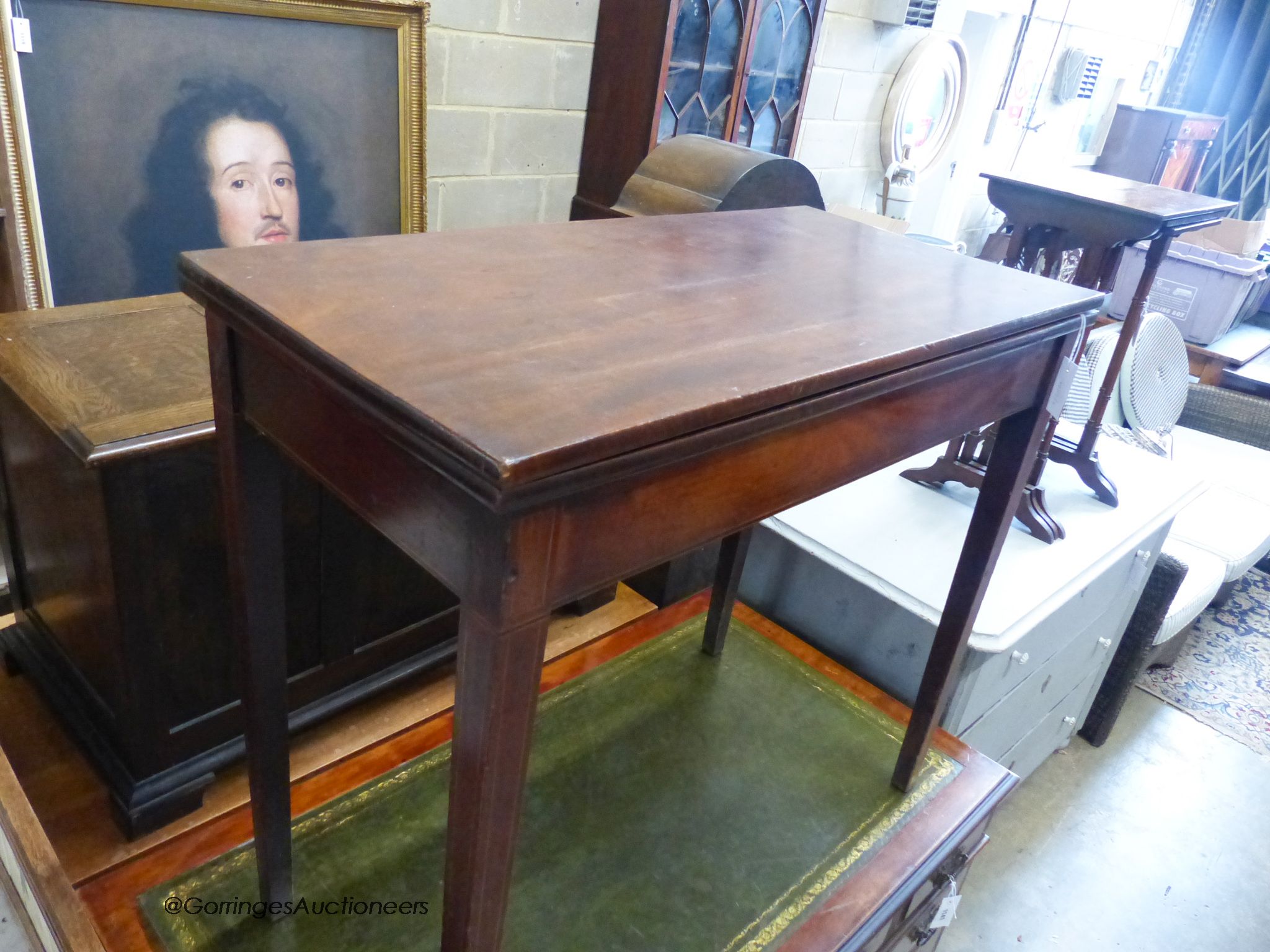 A George III rectangular mahogany folding tea table. W-91cm, D-45cm, H-79cm.